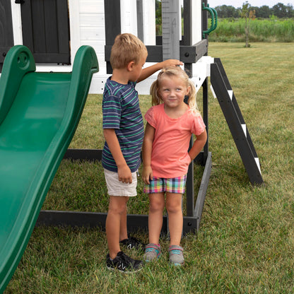 Backyard Discovery Sweetwater Heights cedar wood kids' playhouse with wave slide, toy kitchen, growth chart, outdoor garden structure.