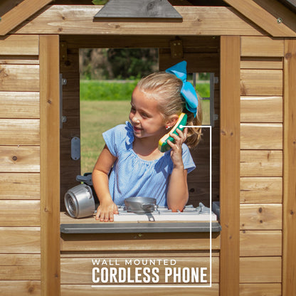 Backyard Discovery Maple Leaf cedar wood children's playhouse with play kitchen, snack bar window, and half door in outdoor garden setting.