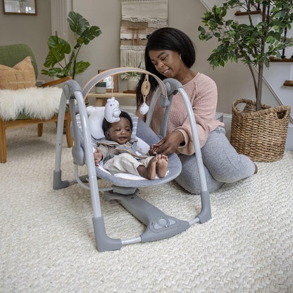Ingenuity Swing 'n Go Deluxe baby swing with cushioned harness, plush toys, sounds, foldable design, suitable for 0-9 months.