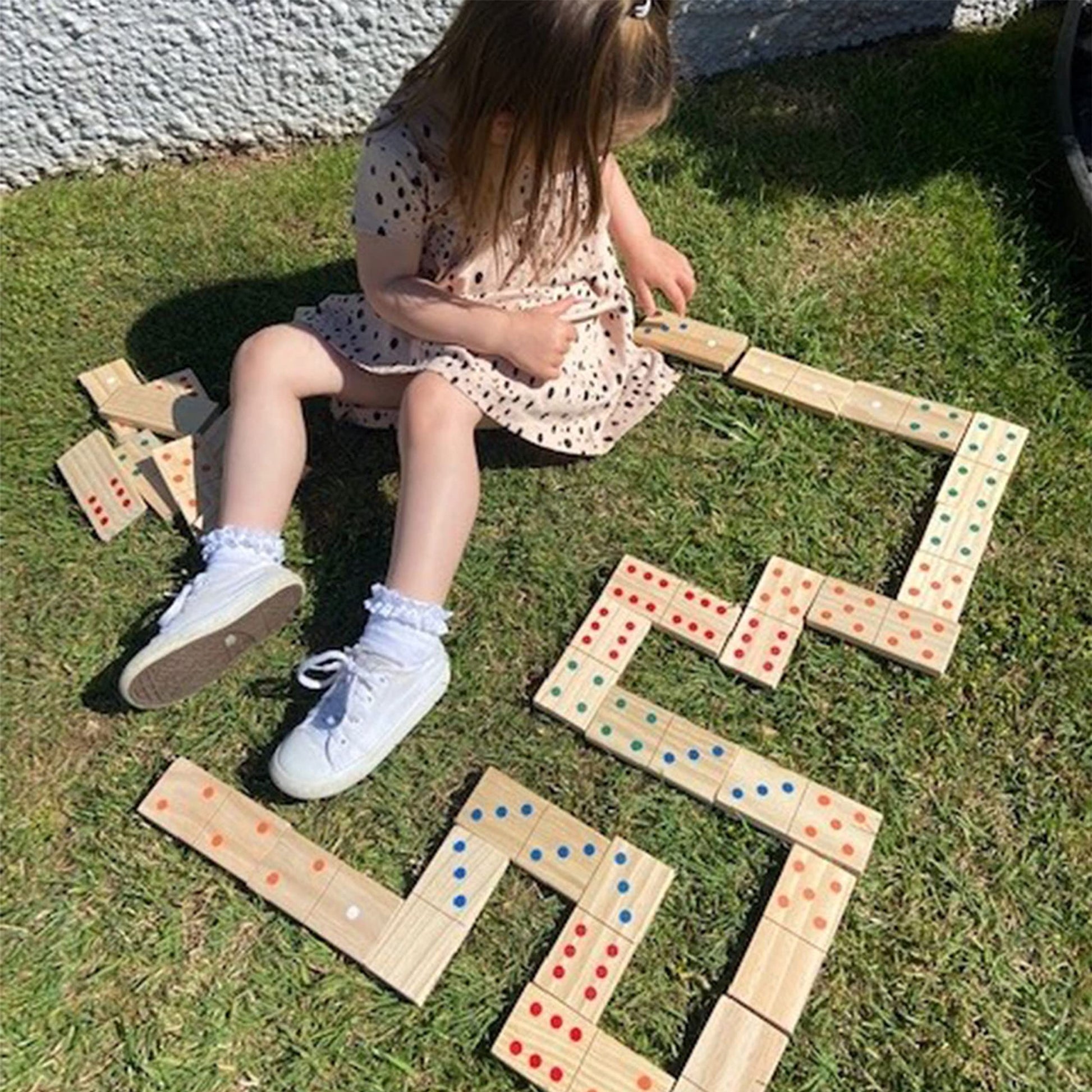Wooden giant dominoes set by Jaques of London for kids, outdoor garden game with large, colorful domino pieces for children.