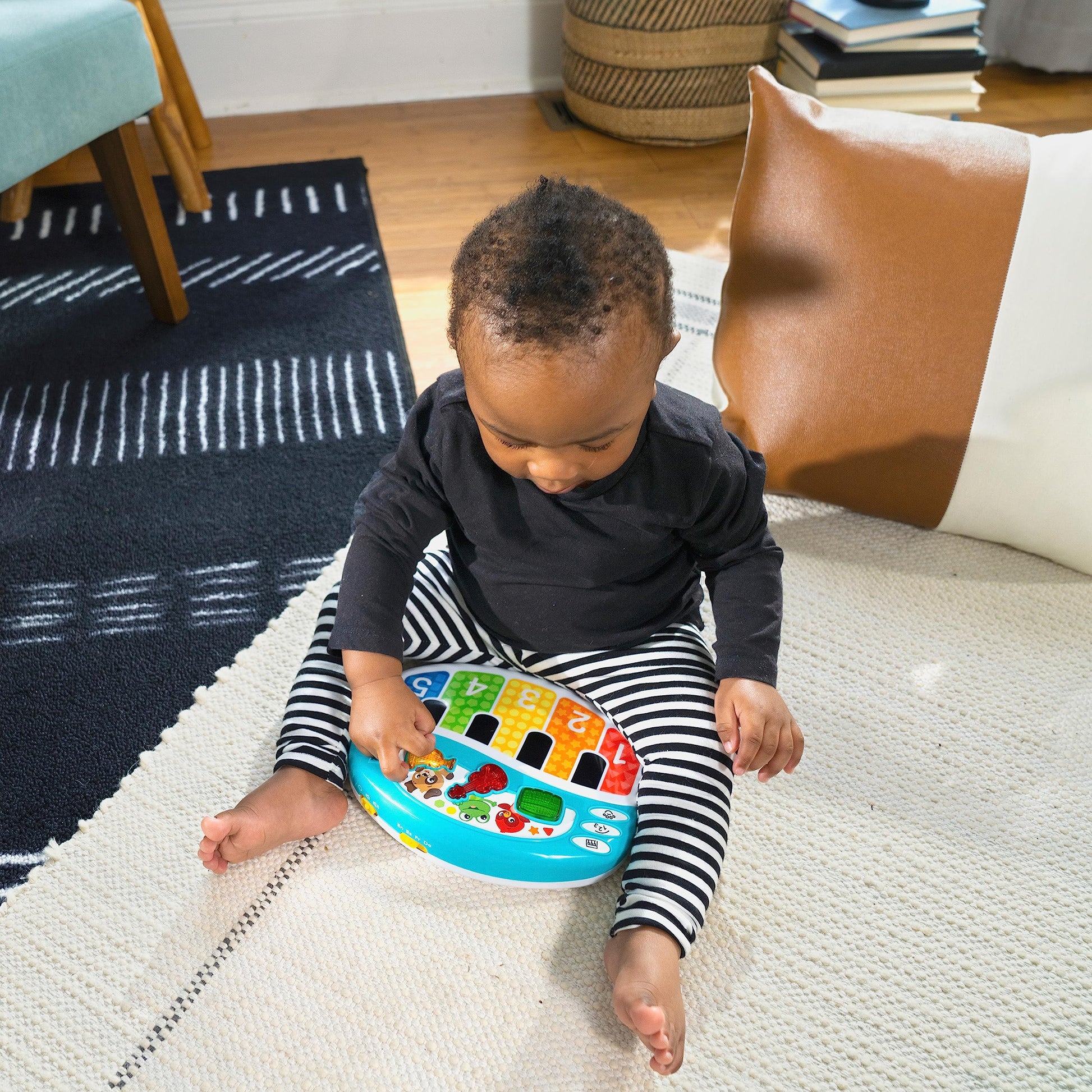 Baby Einstein Discover & Play Piano toy with colorful buttons, showing musical instruments, numbers, animals, and multilingual features.
