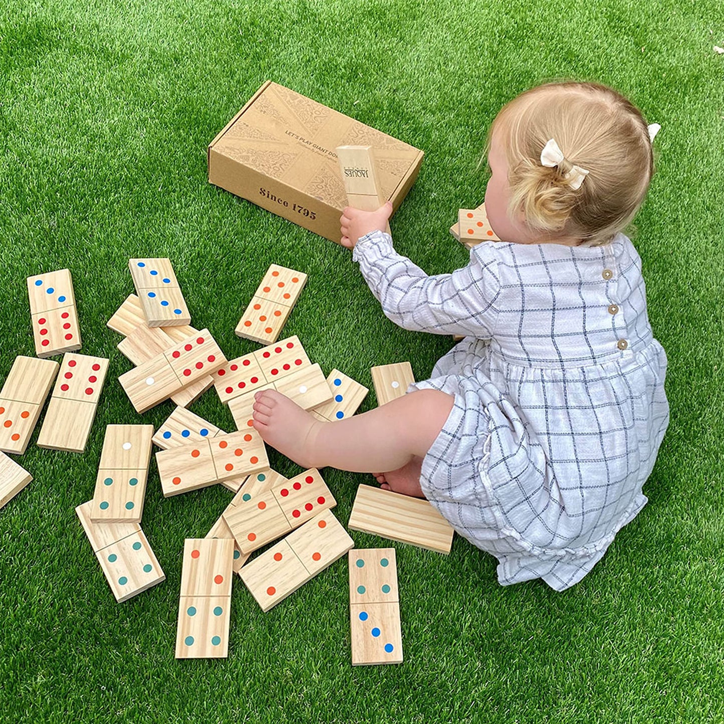 Set of Jaques of London wooden giant dominoes arranged outdoors, designed for kids' garden games and outdoor play.